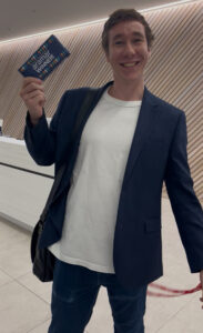 Nick from AB Foods smiling and holding a winning Aramar tonychocolonely chocolate bar 